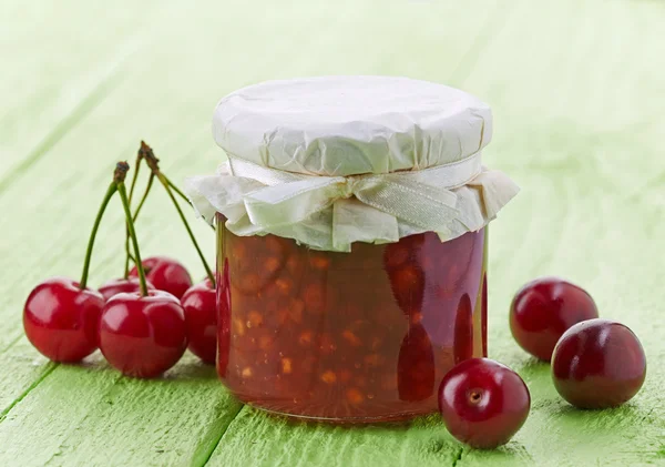 Jar of cherry and apple jam — Stock Photo, Image