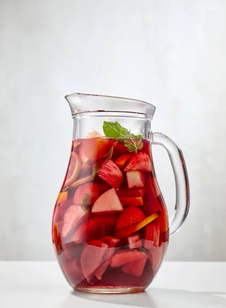 jug of red sangria on white restaurant table