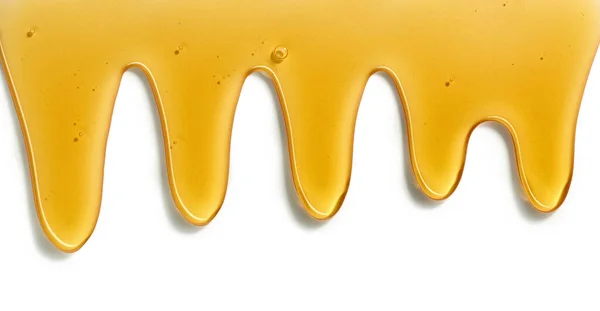 白い背景に分離されて流れる蜂蜜 — ストック写真