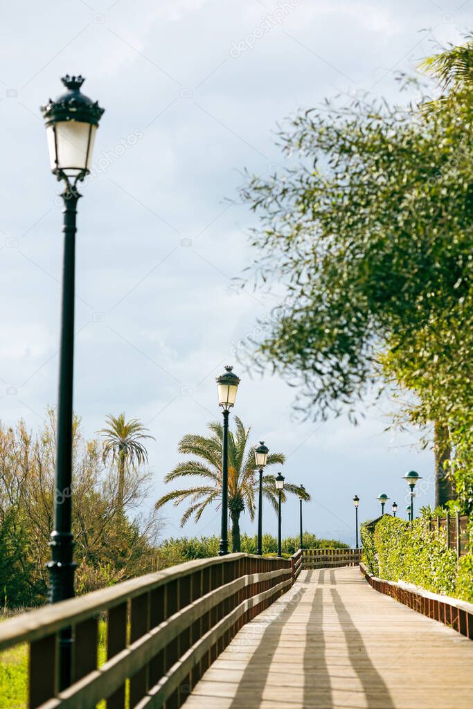 Landscape with wooden walkway to Marbella beach, Spain in January