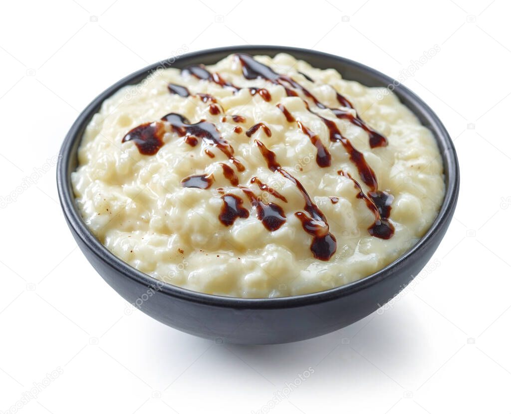bowl of gluten free rice milk pudding decorated with chocolate sauce isolated on white background