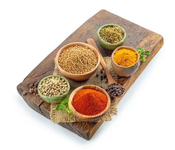 various spices on wooden board isolated on white background