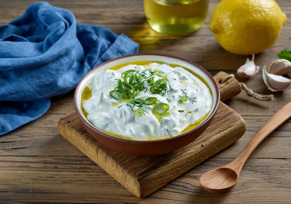 bowl of sour cream or greek yogurt on wooden kitchen table