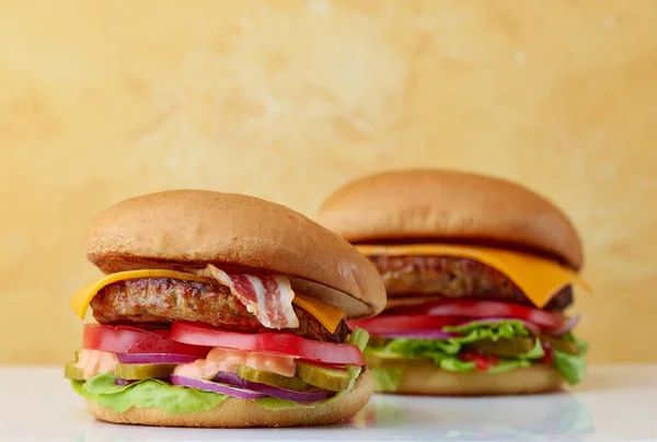 Two Fresh Burgers Yellow Background Selective Focus — Stock Fotó