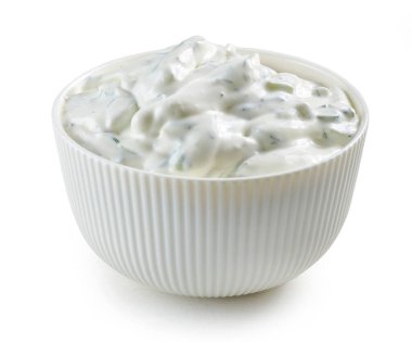 bowl of sour cream or greek yogurt tzatziki sauce on white kitchen table
