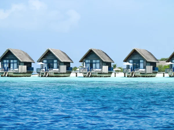 Water bungalows with steps beside sea — Stock Photo, Image