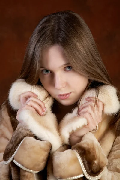 Studio portrait of the girl in a fur coat — Stock Photo, Image