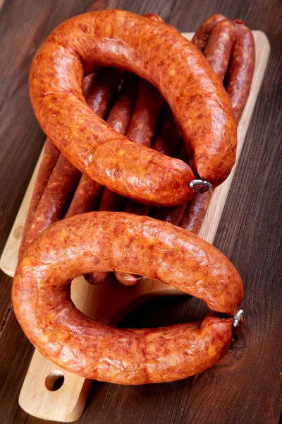 Smoked sausage on a kitchen table — Stock Photo, Image