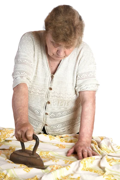 The grandmother irons fabric the ancient iron on a white backgr — Stock Photo, Image