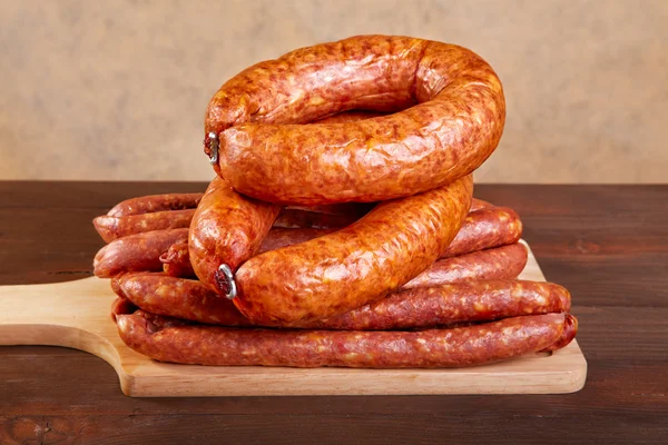 Smoked sausage on a kitchen table — Stock Photo, Image