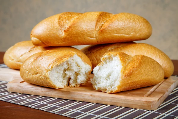 Pile of white rolls on a kitchen table — Stock Photo, Image