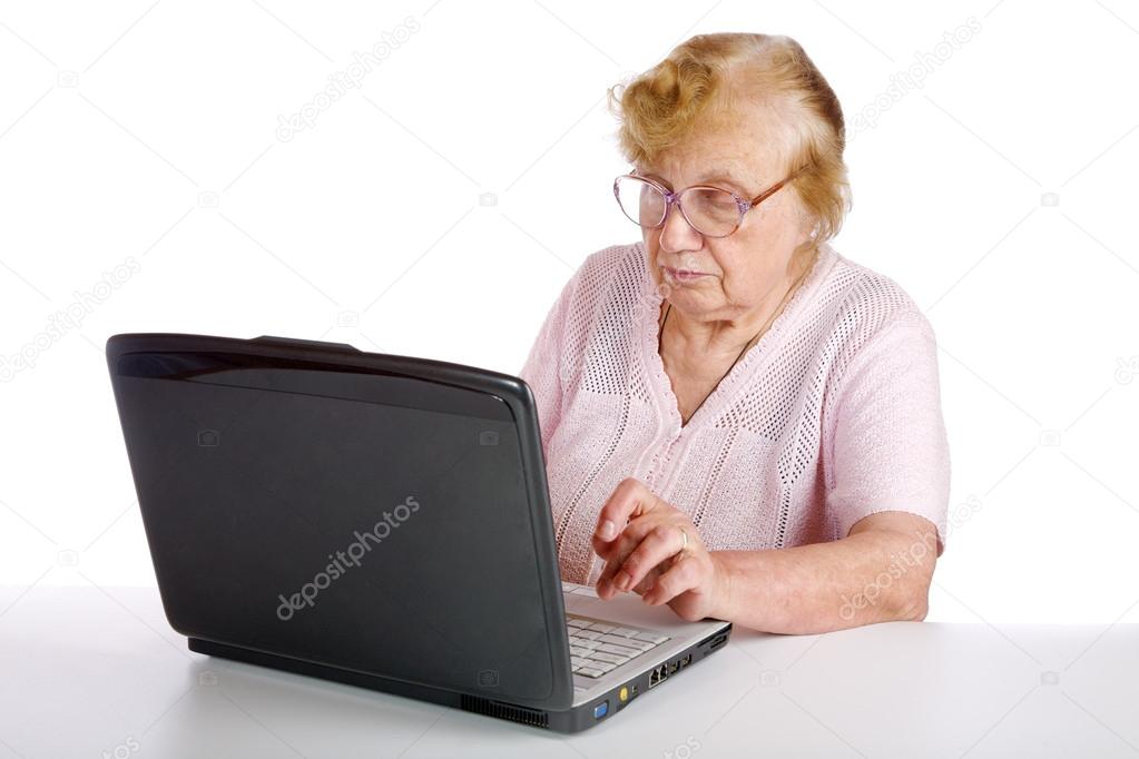 granny in glasses looks at the screen notebook on a white backgr