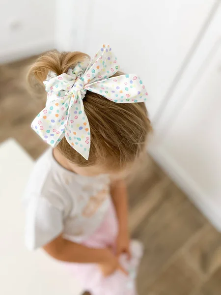 A beautiful  bow is an accessory for the hair on the girl