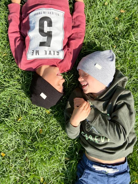 两个可爱的孩子躺在草地上 — 图库照片