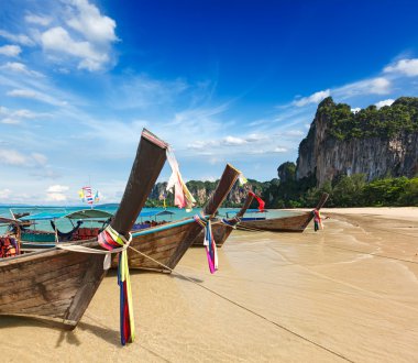 Long tail boats on beach, Thailand clipart