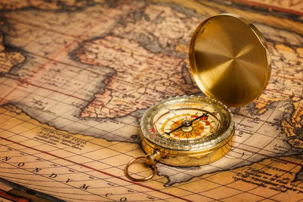 Old vintage golden compass on ancient map — Stock Photo, Image
