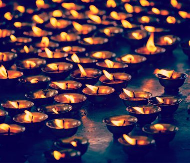 Burning candles in Buddhist temple clipart