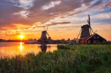 Gün batımında Hollanda 'daki Zaanse Schans' da yel değirmenleri. Zaandam, Nether