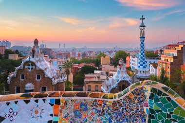 Barcelona city view from Guell Park. Sunrise view of colorful mosaic building in Park Guell clipart
