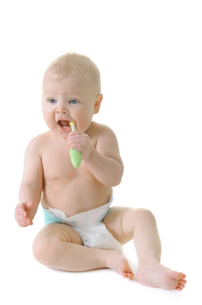 Little baby girl with teething brush — Stock Photo, Image