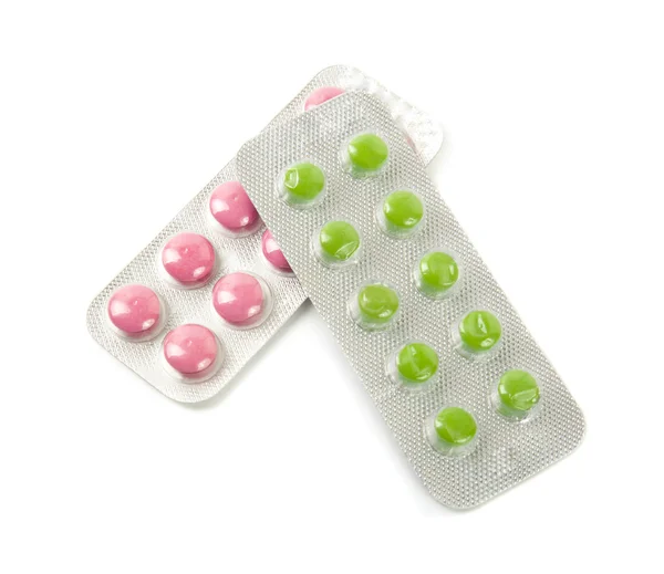 Paket mit rosa und grünen Tabletten — Stockfoto