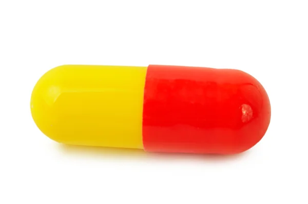 Single red-yellow medical pills — Stok fotoğraf