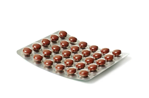 Pakket met bruin tabletten — Stockfoto