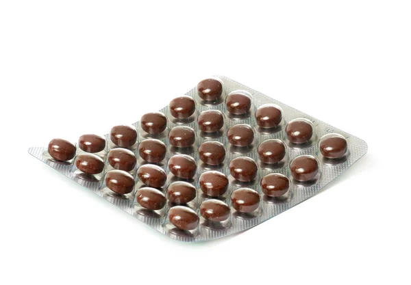 Kahverengi tabletler ile paket — Stok fotoğraf