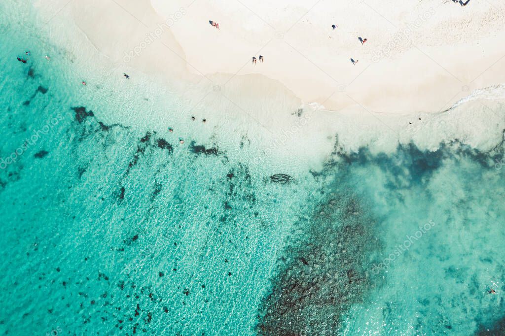 Beautiful caribbean beach in Dominican Republic. Aerial abstract view of tropical idyllic summer landscape with small figures of people, sea coast and white sand