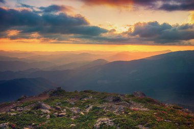 Amazing mountain landscape with colorful vivid sunrise on the dramatic sky, natural outdoor travel background. Beauty world. Panoramic view.