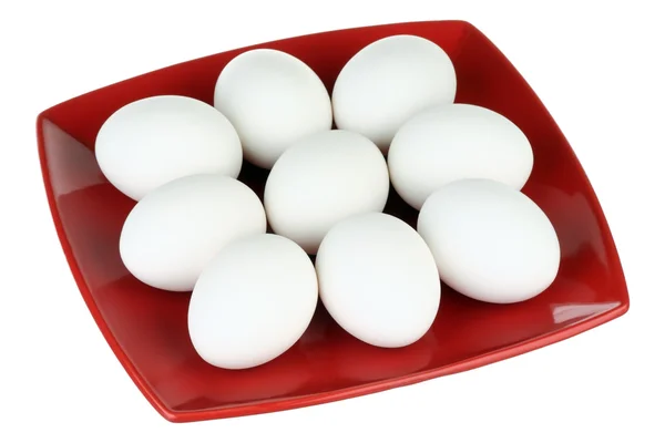 Huevos blancos y plato rojo —  Fotos de Stock