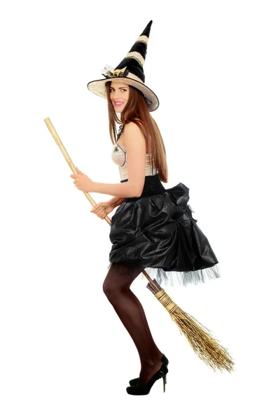 Playful young woman with a besom — Stock Photo, Image