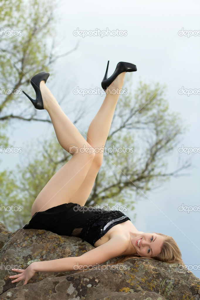Blonde lying on the rock