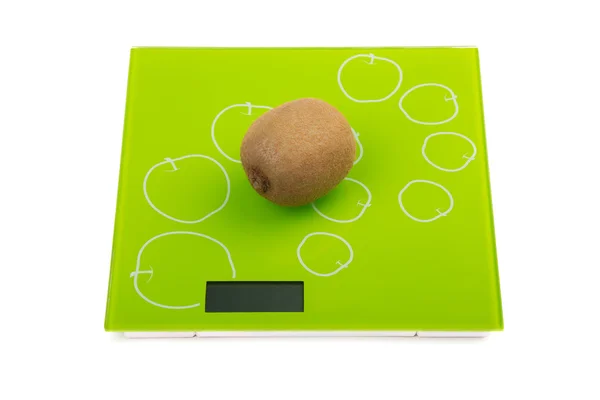 Kiwi fruit on kitchen scales — Stock Photo, Image