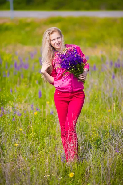 Blond woman with flowers — Stock Photo, Image