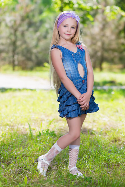 Little blond girl in jeans dress