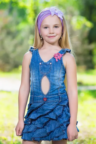 Little blond girl in jeans dress — Stock Photo, Image