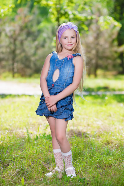 Little blond girl in jeans dress