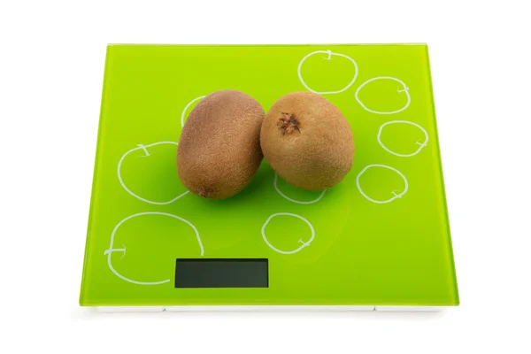 Two kiwi fruit on scales — Stock Photo, Image