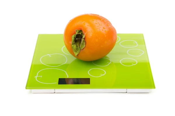 Persimmon on square scales — Stock Photo, Image