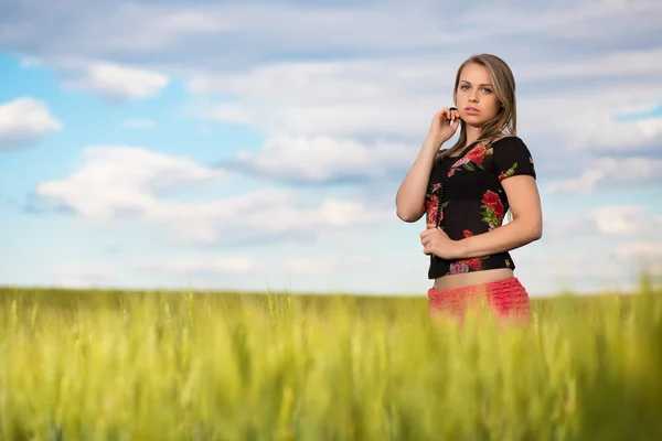 Thoughtful young lady on the wheat field — Stock Photo, Image