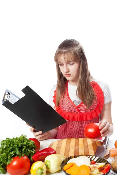 Girl the cook prepares according to the book of recipes — Stock Photo, Image