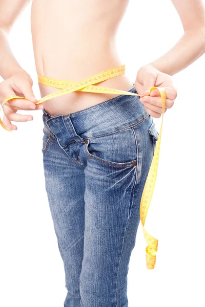 Slender young Woman measuring herself — Stock Photo, Image