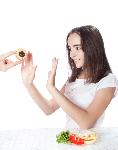 Young woman refuses cake and chooses salad — Stock Photo, Image