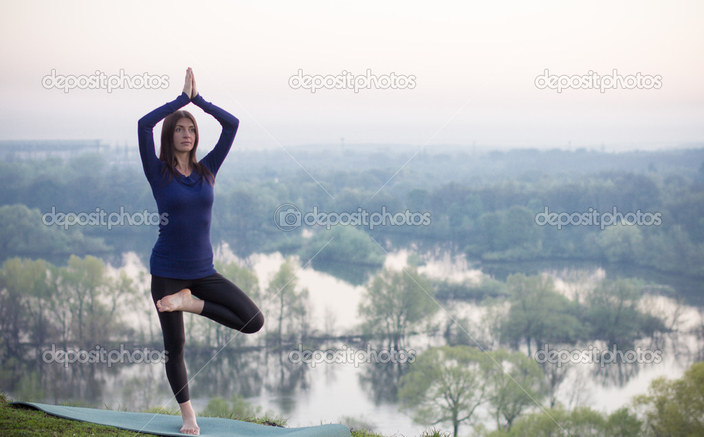 Yoga woman on green park background