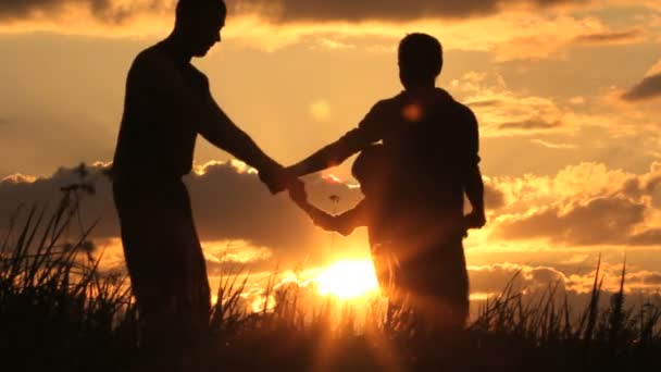 Padre e hijo juegan. Puesta de sol — Vídeo de stock