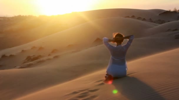 Vrouw doen yoga in de wildernis bij zonsondergang tegen een prachtige woestijn achtergrond — Stockvideo