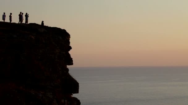 Al atardecer en la roca — Vídeos de Stock