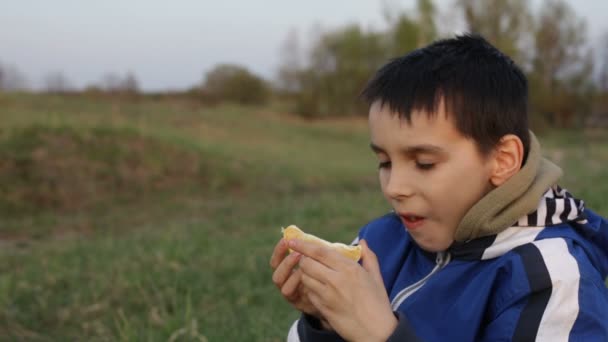 男孩吃橙春天 — 图库视频影像