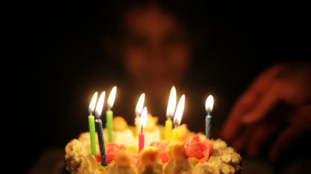 Boy claps and blows out candles on birthday cake. — Stock Video